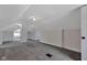 This finished attic features neutral paint, carpet and modern lighting at 2137 Ringgold Ave, Indianapolis, IN 46203