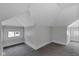 This finished attic features neutral paint, carpet and modern windows at 2137 Ringgold Ave, Indianapolis, IN 46203