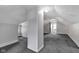 This finished attic features neutral paint and carpet at 2137 Ringgold Ave, Indianapolis, IN 46203