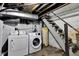 This unfinished basement features a staircase and plumbing for laundry machines at 2137 Ringgold Ave, Indianapolis, IN 46203