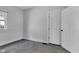 This carpeted bedroom includes classic trim and doors and a bright window at 2137 Ringgold Ave, Indianapolis, IN 46203