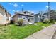 Side view of charming bungalow-style home with a well-maintained lawn and sidewalk at 2137 Ringgold Ave, Indianapolis, IN 46203