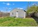 Detached garage with white door and siding is featured in the backyard at 2137 Ringgold Ave, Indianapolis, IN 46203