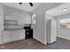 Bright kitchen with white cabinets, black appliances, and vinyl floors at 2137 Ringgold Ave, Indianapolis, IN 46203
