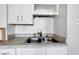 Close-up of a double sink with tile backsplash in a bright kitchen at 2137 Ringgold Ave, Indianapolis, IN 46203