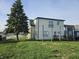 View of the backyard with a chain link fence, a deck, and mature trees at 902 W Main St, Greenfield, IN 46140