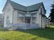 Quaint yellow house with green roof, porch, and small yard at 902 W Main St, Greenfield, IN 46140