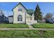 Two-story home featuring a green roof, front porch, and large arched window at 902 W Main St, Greenfield, IN 46140