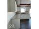 White kitchen cabinets and countertops, gray flooring at 902 W Main St, Greenfield, IN 46140