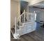 Modern white staircase with built-in shelving at 902 W Main St, Greenfield, IN 46140
