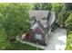 Aerial view of a brick home with mature trees, a spacious driveway, and manicured landscaping at 11633 Trail Ridge Pl, Zionsville, IN 46077