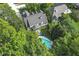 Aerial view of estate with pool, surrounded by mature trees for privacy at 11633 Trail Ridge Pl, Zionsville, IN 46077
