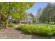 Picturesque backyard with lush greenery, swimming pool, deck and plenty of space for entertaining at 11633 Trail Ridge Pl, Zionsville, IN 46077