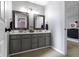 Stylish bathroom with double vanities, framed mirrors, neutral walls, and convenient access to the hallway at 11633 Trail Ridge Pl, Zionsville, IN 46077