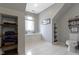 Bathroom featuring a toilet, a small window, built-in wall shelving and tile floor at 11633 Trail Ridge Pl, Zionsville, IN 46077
