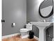 Powder room features a pedestal sink, tile floors, toilet and dark gray paint at 11633 Trail Ridge Pl, Zionsville, IN 46077