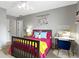Bright and inviting bedroom with a desk and cozy seating area, complemented by a colorful heart decoration at 11633 Trail Ridge Pl, Zionsville, IN 46077