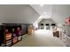 Spacious bonus room under a slanted ceiling with multiple desks, chalkboard wall, and comfortable seating area at 11633 Trail Ridge Pl, Zionsville, IN 46077