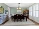 Inviting dining room featuring hardwood floors, a stylish light fixture, and muted sage walls at 11633 Trail Ridge Pl, Zionsville, IN 46077