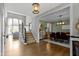 Welcoming foyer with hardwood floors, staircase, and open view to the dining and living areas at 11633 Trail Ridge Pl, Zionsville, IN 46077