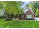 Charming brick home with a lush green lawn and mature landscaping at 11633 Trail Ridge Pl, Zionsville, IN 46077