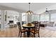 Open concept kitchen and dining area next to living room with large windows at 11633 Trail Ridge Pl, Zionsville, IN 46077