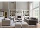 Bright living room features a fireplace, built-in shelving, and large windows at 11633 Trail Ridge Pl, Zionsville, IN 46077