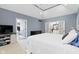 Bright main bedroom with ceiling fan, and white french doors leading to a sitting area at 11633 Trail Ridge Pl, Zionsville, IN 46077