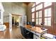 Elegant office with vaulted ceiling, large windows, shutters, hardwood floors, and wood trim at 11633 Trail Ridge Pl, Zionsville, IN 46077