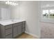 Modern bathroom with gray vanity and a view to another room at 3885 Wren Dr, Brownsburg, IN 46112