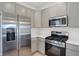 Modern kitchen with gray cabinets and stainless steel appliances at 3885 Wren Dr, Brownsburg, IN 46112