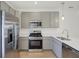 Modern kitchen with gray cabinets and stainless steel appliances at 3885 Wren Dr, Brownsburg, IN 46112