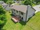Aerial view showcases the home's large backyard, wooden deck, mature trees, and well-maintained lawn at 1936 Broadmoor Ln, Columbus, IN 47203