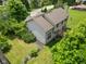 Aerial view of the home highlighting the backyard, wooden deck, mature trees, and spacious lot in a quiet neighborhood at 1936 Broadmoor Ln, Columbus, IN 47203