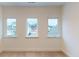 Bright bedroom with three windows and carpet at 9870 Bucklebury Ln, Carmel, IN 46280