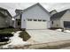 Two-story light blue house with a white garage door and small front yard at 9870 Bucklebury Ln, Carmel, IN 46280