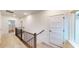 Upstairs hallway with railing and carpet at 9870 Bucklebury Ln, Carmel, IN 46280