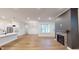Open living area with fireplace and large windows at 9870 Bucklebury Ln, Carmel, IN 46280