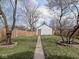 Well-maintained backyard with a grass lawn, wooden fence, and a detached garage at 1210 Finley Ave, Indianapolis, IN 46203