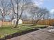 Inviting backyard featuring a stone patio, grass lawn, and garden beds at 1210 Finley Ave, Indianapolis, IN 46203