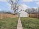 Spacious backyard with green grass, a wooden fence, and a detached garage at 1210 Finley Ave, Indianapolis, IN 46203