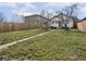 View of backyard with grass, trees, patio area, and walkway leading to the house at 1210 Finley Ave, Indianapolis, IN 46203