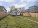 Grassy backyard with a pathway to the house, framed by trees and a wood fence at 1210 Finley Ave, Indianapolis, IN 46203