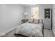 Bright bedroom featuring a patterned comforter, a neutral color palette and simple decor at 1210 Finley Ave, Indianapolis, IN 46203
