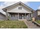 Inviting home with a classic front porch and well-maintained landscaping at 1210 Finley Ave, Indianapolis, IN 46203