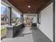 Inviting covered front porch with wood ceiling, brick columns and a porch swing at 1210 Finley Ave, Indianapolis, IN 46203