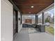 Inviting covered front porch with wood ceiling, brick columns and seating at 1210 Finley Ave, Indianapolis, IN 46203