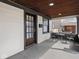 Inviting covered front porch with wood ceiling, brick columns and seating at 1210 Finley Ave, Indianapolis, IN 46203