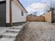 Exterior view of a garage with a gray gravel driveway and access steps at 1210 Finley Ave, Indianapolis, IN 46203