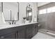 Elegant bathroom featuring double sinks, quartz counters, and a glass enclosed shower at 1659 Midland Main St, Westfield, IN 46074